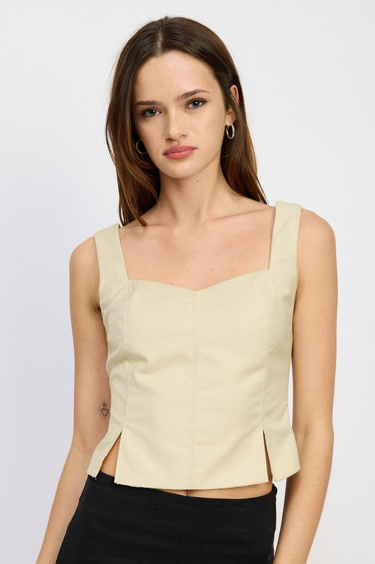 BUSTIER TOP WITH SLIT DETAILSIZE &amp; FIT :MODEL WEARS SIZE SMALLMODEL'S HEIGHT 5'9Made In: IMPORTEDFabric Contents: 80% POLYESTER, 20% RAYONLINING: 100% POLYESTER