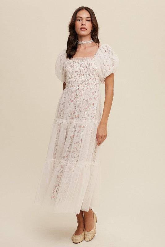 Floral Print and Mesh Puff Sleeve Maxi DressIntroducing our Floral Print and Mesh Puff Sleeve Maxi Dress, a captivating blend of sophistication and charm. This dress features a square neckline adorned with ela