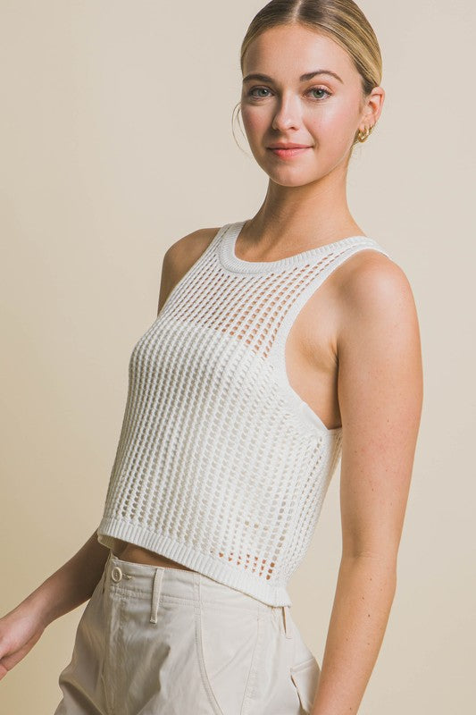 Sleeveless Open Knit Crop TopThe Sleeveless Open Knit Crop Top is a versatile piece that adds a touch of texture to your outfit. Its sleeveless design makes it perfect for warm weather, while th