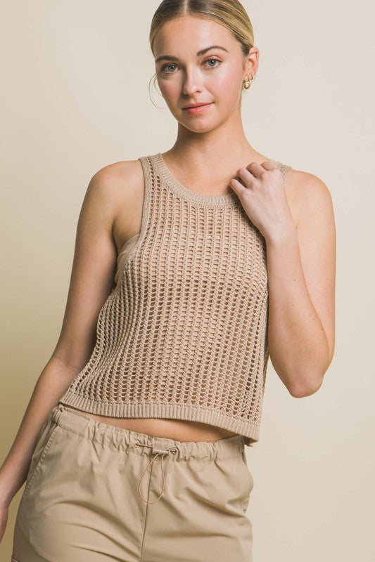 Sleeveless Open Knit Crop TopThe Sleeveless Open Knit Crop Top is a versatile piece that adds a touch of texture to your outfit. Its sleeveless design makes it perfect for warm weather, while th