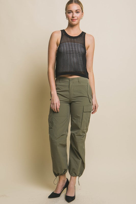 Sleeveless Open Knit Crop TopThe Sleeveless Open Knit Crop Top is a versatile piece that adds a touch of texture to your outfit. Its sleeveless design makes it perfect for warm weather, while th