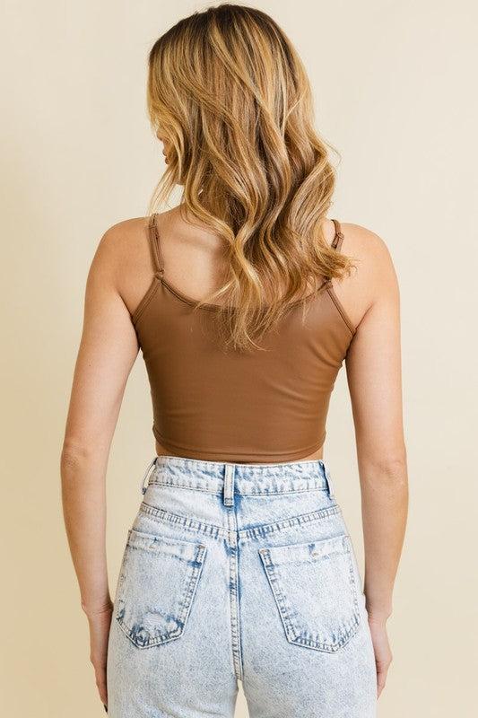 Strap Faux Leather Crop Cami TopFlaunt an audacious look with our Strap Faux Leather Crop Cami Top, a fashion-forward essential for your spring and summer wardrobe. Its faux leather finish and crop