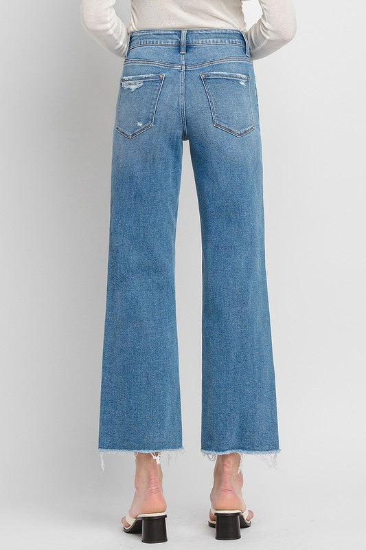 High Rise Ankle Slim Wide JeansExperience modern style with our High Rise Ankle Slim Wide Jeans. Crafted from comfort stretch denim, these jeans feature a high rise waist and a raw hem for a conte