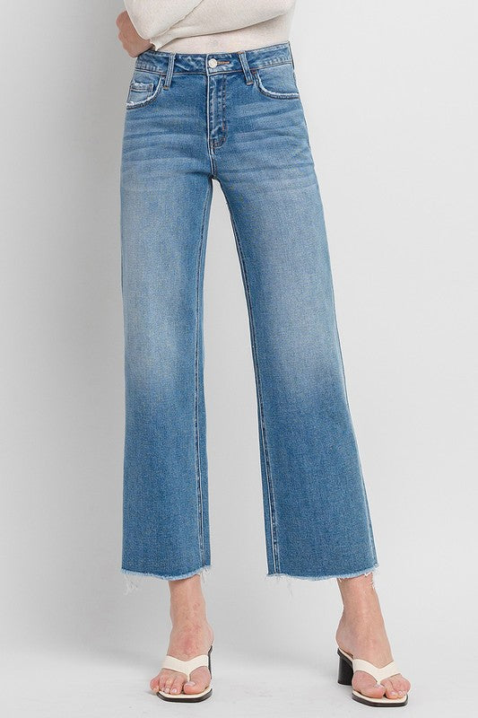 High Rise Ankle Slim Wide JeansExperience modern style with our High Rise Ankle Slim Wide Jeans. Crafted from comfort stretch denim, these jeans feature a high rise waist and a raw hem for a conte