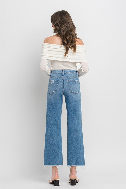 High Rise Ankle Slim Wide JeansExperience modern style with our High Rise Ankle Slim Wide Jeans. Crafted from comfort stretch denim, these jeans feature a high rise waist and a raw hem for a conte