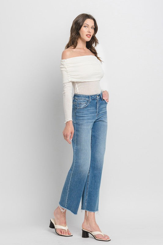 High Rise Ankle Slim Wide JeansExperience modern style with our High Rise Ankle Slim Wide Jeans. Crafted from comfort stretch denim, these jeans feature a high rise waist and a raw hem for a conte