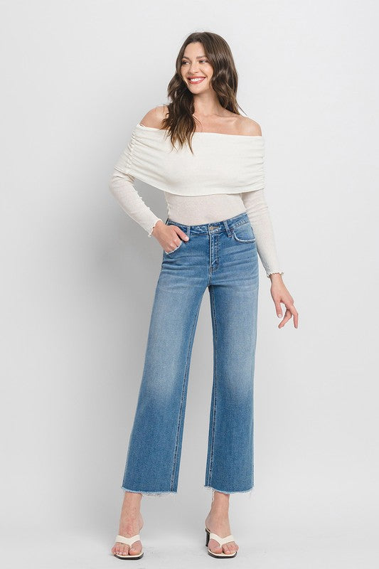 High Rise Ankle Slim Wide JeansExperience modern style with our High Rise Ankle Slim Wide Jeans. Crafted from comfort stretch denim, these jeans feature a high rise waist and a raw hem for a conte