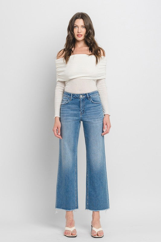 High Rise Ankle Slim Wide JeansExperience modern style with our High Rise Ankle Slim Wide Jeans. Crafted from comfort stretch denim, these jeans feature a high rise waist and a raw hem for a conte