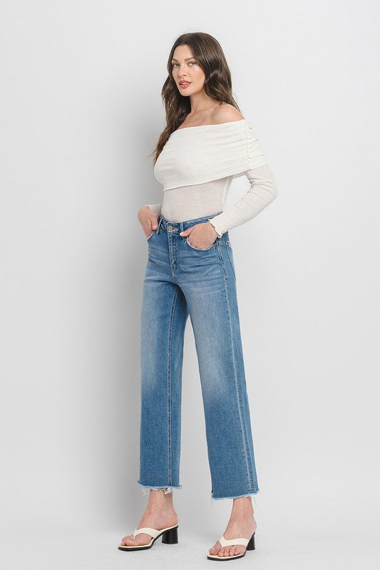 High Rise Ankle Slim Wide JeansExperience modern style with our High Rise Ankle Slim Wide Jeans. Crafted from comfort stretch denim, these jeans feature a high rise waist and a raw hem for a conte