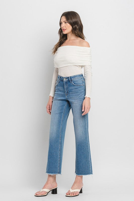 High Rise Ankle Slim Wide JeansExperience modern style with our High Rise Ankle Slim Wide Jeans. Crafted from comfort stretch denim, these jeans feature a high rise waist and a raw hem for a conte