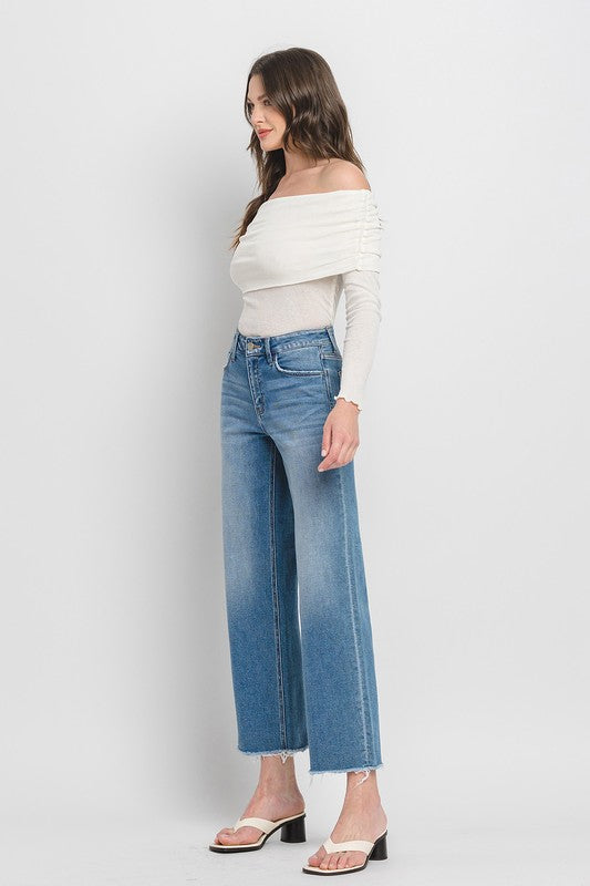 High Rise Ankle Slim Wide JeansExperience modern style with our High Rise Ankle Slim Wide Jeans. Crafted from comfort stretch denim, these jeans feature a high rise waist and a raw hem for a conte