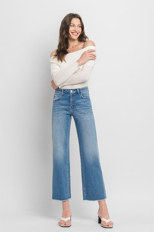 High Rise Ankle Slim Wide JeansExperience modern style with our High Rise Ankle Slim Wide Jeans. Crafted from comfort stretch denim, these jeans feature a high rise waist and a raw hem for a conte