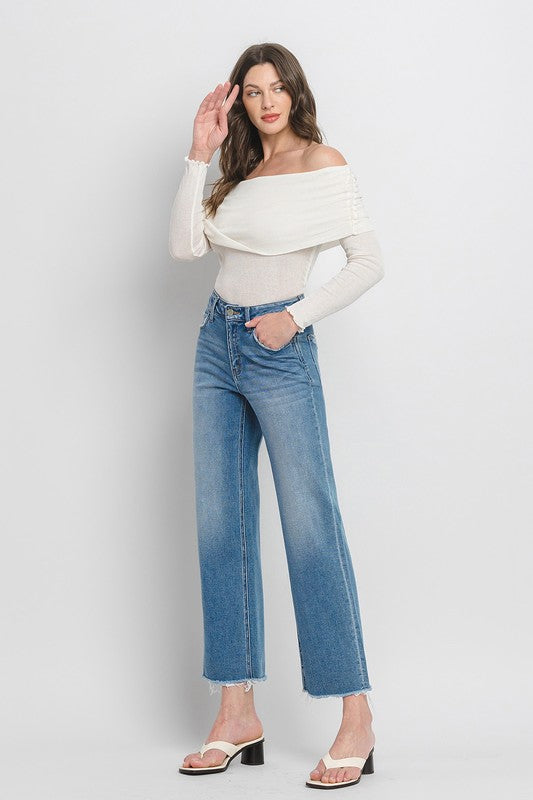 High Rise Ankle Slim Wide JeansExperience modern style with our High Rise Ankle Slim Wide Jeans. Crafted from comfort stretch denim, these jeans feature a high rise waist and a raw hem for a conte