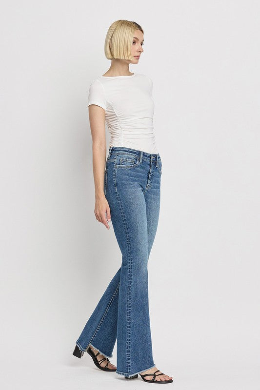 High Rise Slant Hem Flare JeansElevate your denim game with our High Rise Slant Hem Flare Jeans. Featuring a comfortable high rise waist and a unique slant hem design, these jeans offer a modern t