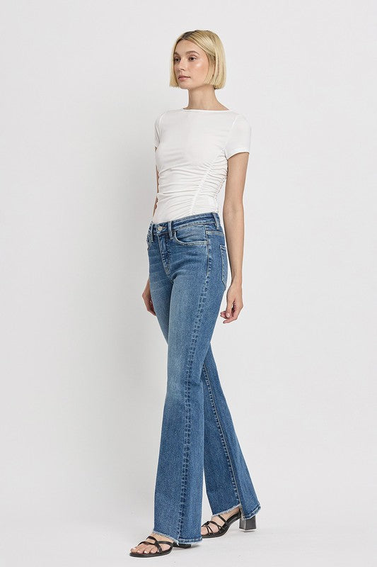 High Rise Slant Hem Flare JeansElevate your denim game with our High Rise Slant Hem Flare Jeans. Featuring a comfortable high rise waist and a unique slant hem design, these jeans offer a modern t