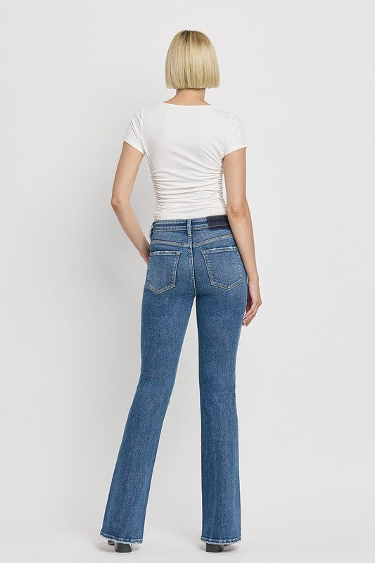 High Rise Slant Hem Flare JeansElevate your denim game with our High Rise Slant Hem Flare Jeans. Featuring a comfortable high rise waist and a unique slant hem design, these jeans offer a modern t