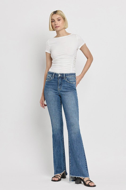 High Rise Slant Hem Flare JeansElevate your denim game with our High Rise Slant Hem Flare Jeans. Featuring a comfortable high rise waist and a unique slant hem design, these jeans offer a modern t