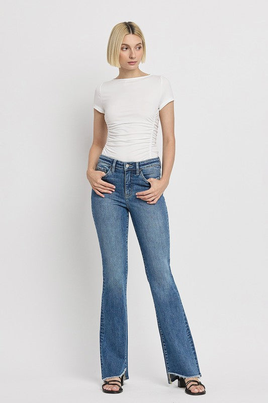 High Rise Slant Hem Flare JeansElevate your denim game with our High Rise Slant Hem Flare Jeans. Featuring a comfortable high rise waist and a unique slant hem design, these jeans offer a modern t