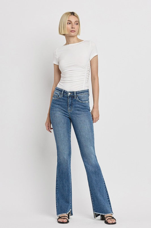 High Rise Slant Hem Flare JeansElevate your denim game with our High Rise Slant Hem Flare Jeans. Featuring a comfortable high rise waist and a unique slant hem design, these jeans offer a modern t