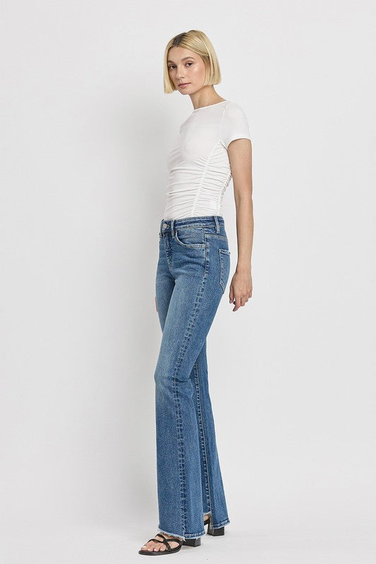 High Rise Slant Hem Flare JeansElevate your denim game with our High Rise Slant Hem Flare Jeans. Featuring a comfortable high rise waist and a unique slant hem design, these jeans offer a modern t