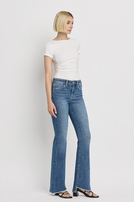 High Rise Slant Hem Flare JeansElevate your denim game with our High Rise Slant Hem Flare Jeans. Featuring a comfortable high rise waist and a unique slant hem design, these jeans offer a modern t