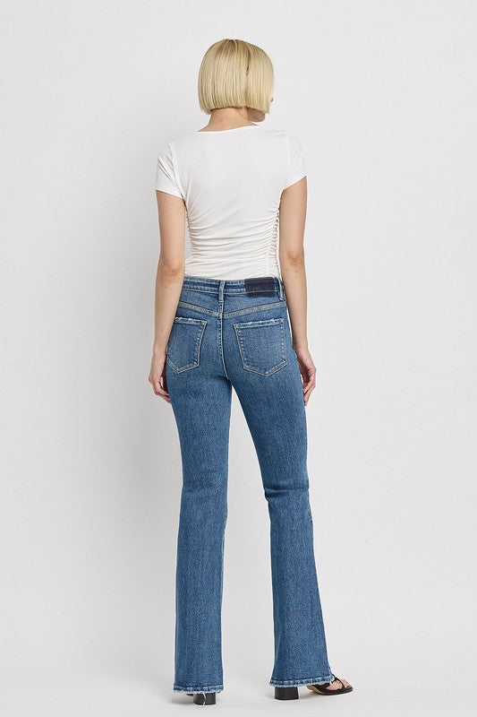 High Rise Slant Hem Flare JeansElevate your denim game with our High Rise Slant Hem Flare Jeans. Featuring a comfortable high rise waist and a unique slant hem design, these jeans offer a modern t