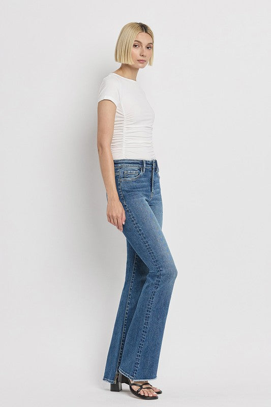 High Rise Slant Hem Flare JeansElevate your denim game with our High Rise Slant Hem Flare Jeans. Featuring a comfortable high rise waist and a unique slant hem design, these jeans offer a modern t