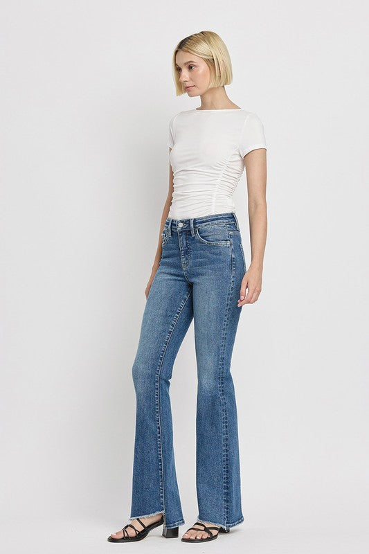 High Rise Slant Hem Flare JeansElevate your denim game with our High Rise Slant Hem Flare Jeans. Featuring a comfortable high rise waist and a unique slant hem design, these jeans offer a modern t