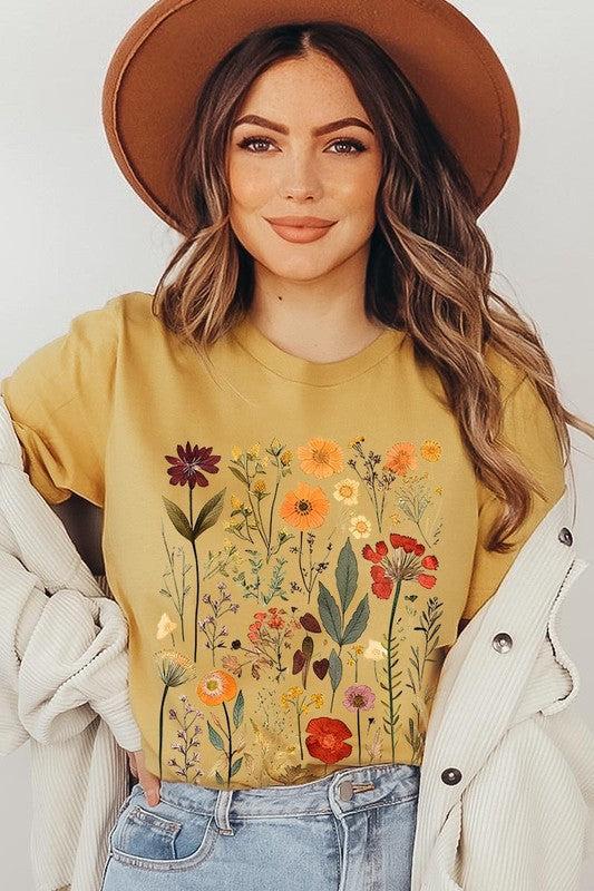 Botanical Wildflowers Graphic TeeBotanical Wildflowers Graphic Tee.Unisex Crew Neck Short Sleeve Tees.Crafted from premium materials, tailored to your lifestyle, ensuring a comfortable fit for any o