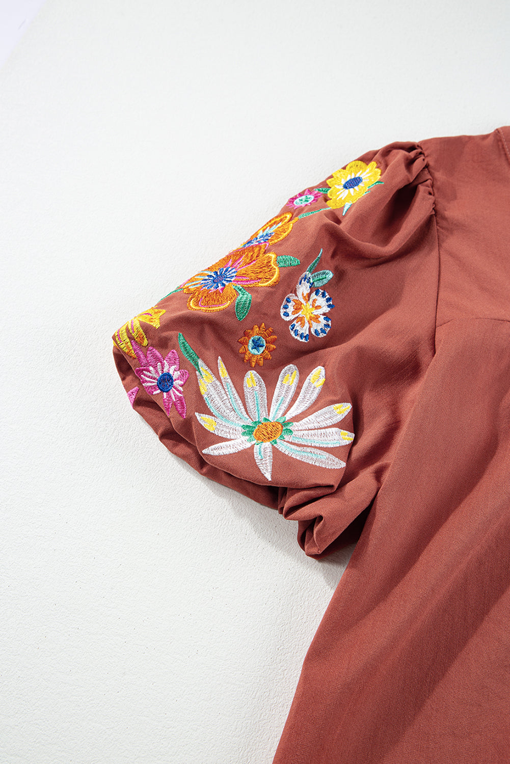 Mineral Red Floral Embroidered Puff Sleeve Split Neck BlouseMaterial:100%Cotton

• Radiate bohemian charm with the Mineral Red blouse featuring intricate floral embroidery and puff sleeves, perfect for a free-spirited look.
