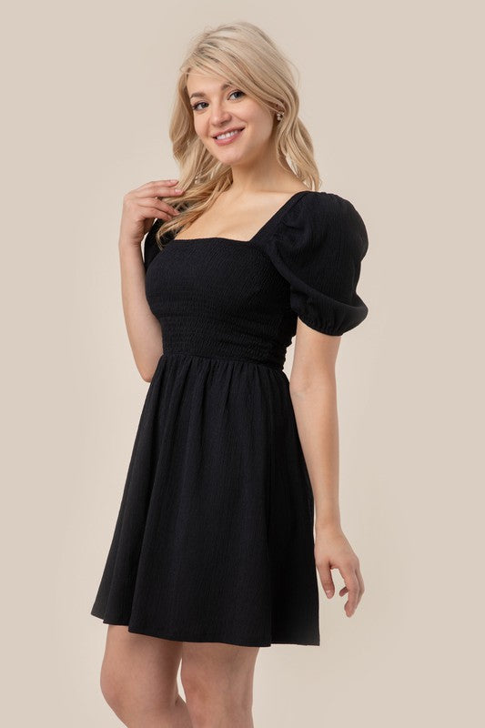 Puff sleeved smocked dress- Puff sleeved smocked dress- Pattern type : solid- Neck line : square neck- Sleeve type : puff sleeves- Sleeve length : short sleeves- Stretch : stretch- Sheer : no