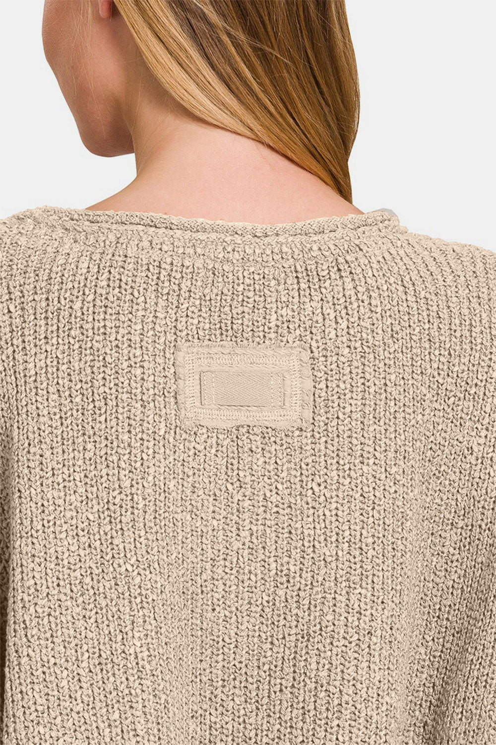 Zenana Notched Side Slit Patch SweaterThe notched side slit patch sweater is a trendy and unique addition to your knitwear collection. With its stylish notched design and side slits, this sweater adds a 