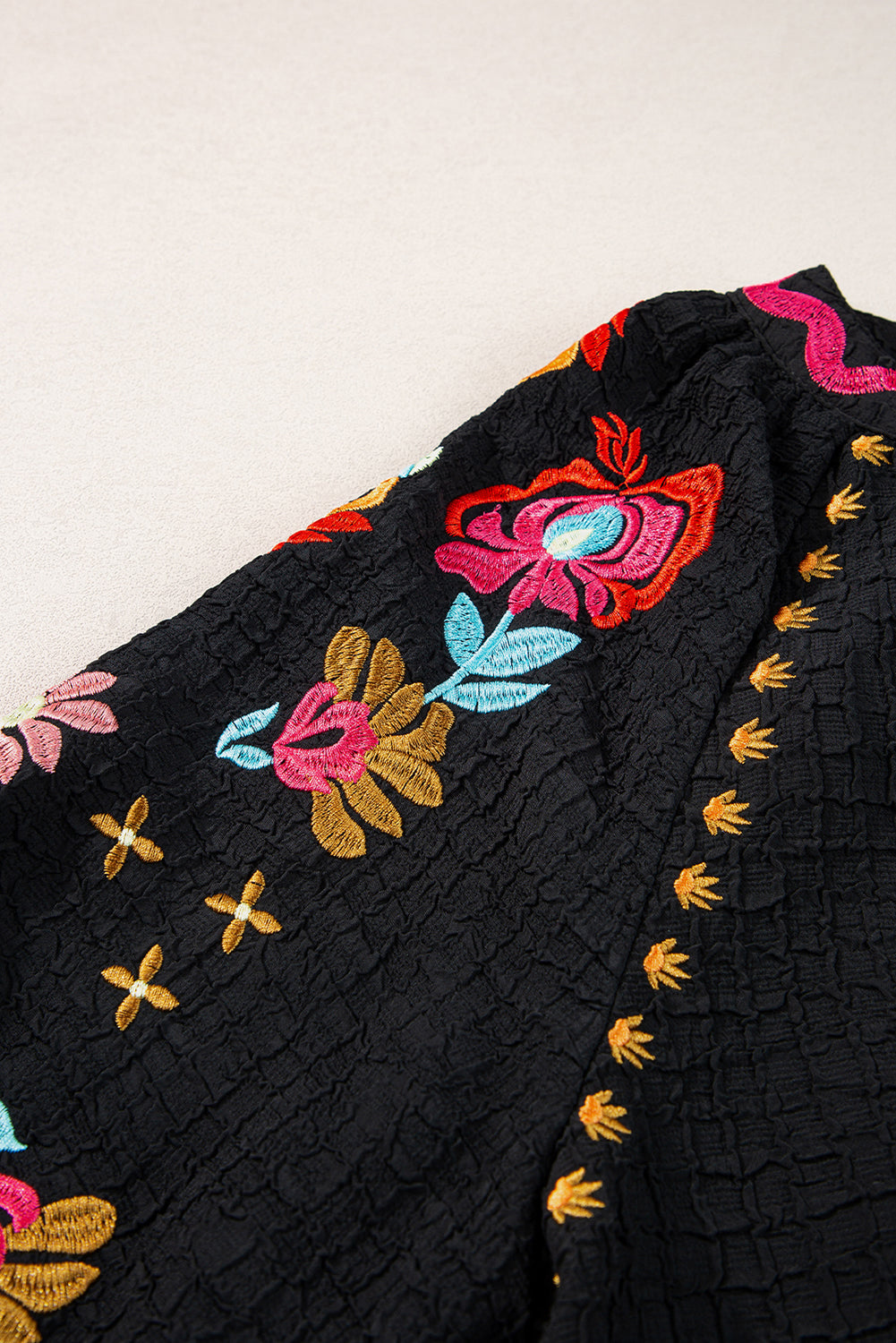 Black Floral Embroidered Ricrac Puff Sleeve Textured BlouseMaterial:100%Polyester

• Intricately detailed floral embroidery adds a touch of whimsy to the classic black hue, perfect for day-to-night transitions.
• The playf