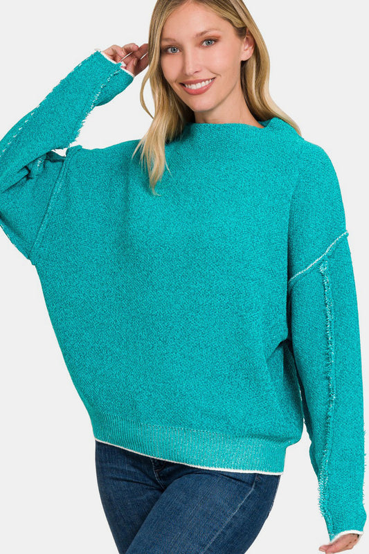 Zenana Exposed Seam Mock Neck Long Sleeve SweaterThis exposed seam mock neck long sleeve sweater showcases a modern, minimalist design. The exposed seam detail adds a touch of chic fashion while bringing a unique v