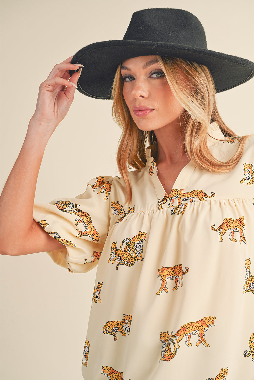 Apricot Animal Print V Neck Puff Sleeve BlouseMaterial:100%Polyester



		The blouse features an animal print pattern, which adds a bold and eye-catching element to the design. 
	
	
		Animal prints, such as