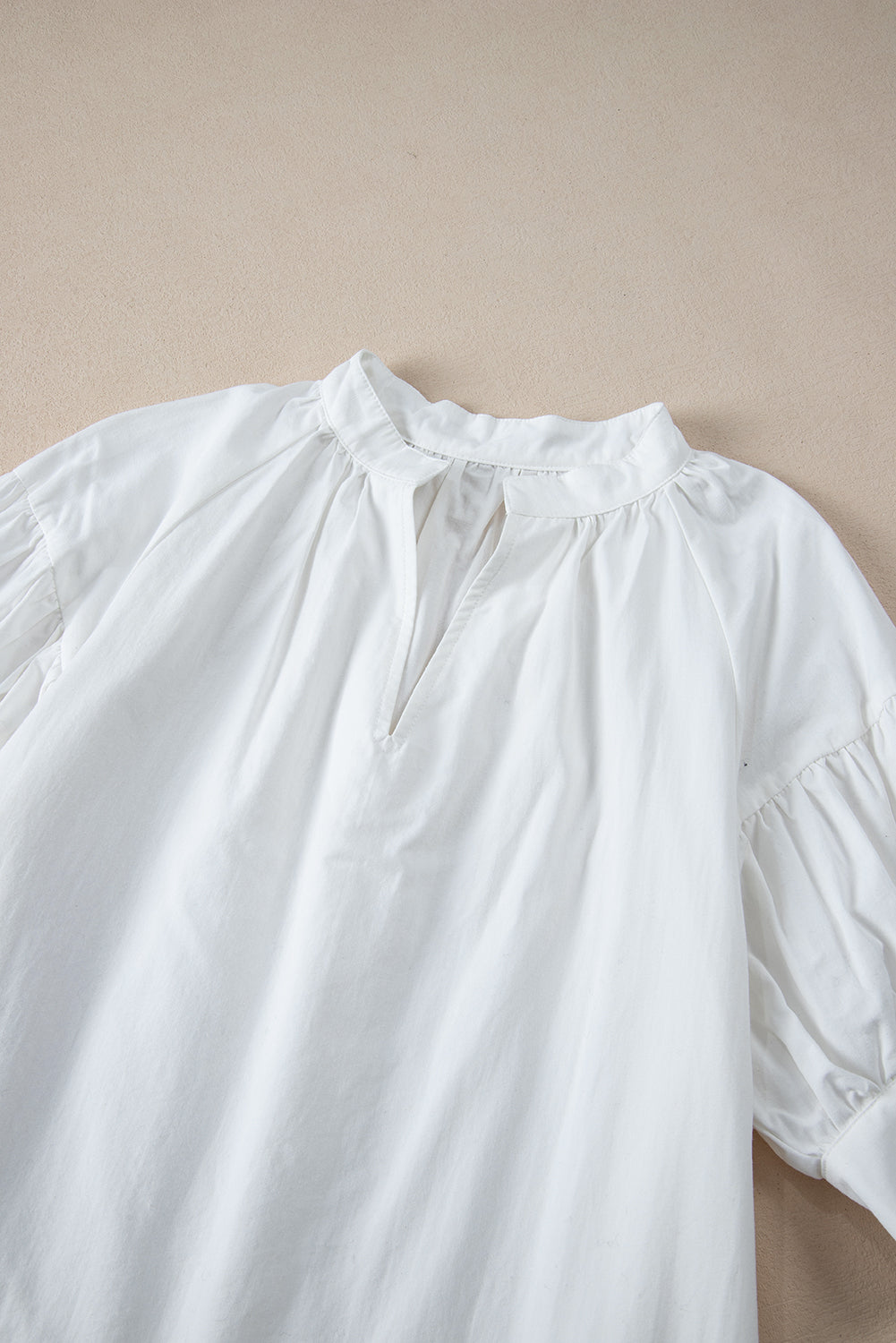 White Solid Color Ruched Bubble Sleeve V Neck ShirtMaterial:100%Cotton

• The ruched detailing on the sleeves adds a touch of texture and visual interest, making this top a standout choice for any occasion. 
• Craf