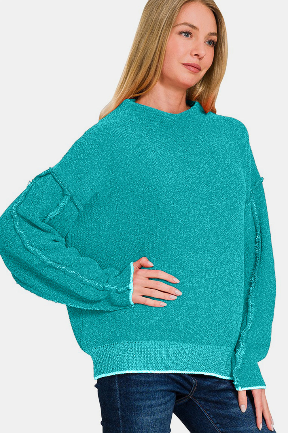 Zenana Exposed Seam Mock Neck Long Sleeve SweaterThis exposed seam mock neck long sleeve sweater showcases a modern, minimalist design. The exposed seam detail adds a touch of chic fashion while bringing a unique v