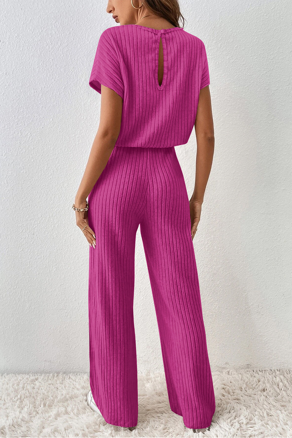 Grass Green Solid Color Ribbed Short Sleeve Wide Leg JumpsuitMaterial:85%Polyester+10%Viscose+5%Elastane



		The jumpsuit is a versatile and trendy one-piece outfit, featuring a solid color design that offers a sleek and mi