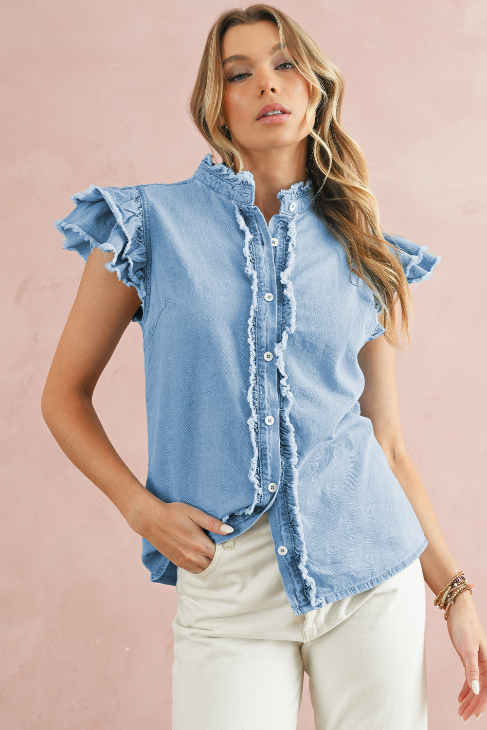 Beau Blue Button Front Ruffled Flutter Frayed Denim TopMaterial:100%Cotton



		The ruffled flutter sleeves create a playful and flirty look, adding movement and charm to the overall design.
	
	
		The frayed detaili