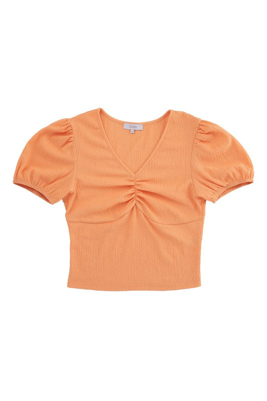 Shirred V neck top with puff sleeves- Shirred V neck top with puff sleeves- Pattern type : solid- Neck line : V neck- Sleeve type : puff sleeves- Sleeve length : short sleeves- Stretch : stretch- Sheer