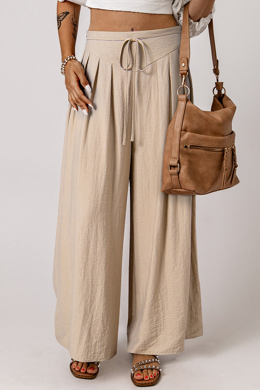 Beige Casual Lace-up Waist Pleated Wide Leg PantsMaterial:67%Viscose+21%Polyamide+12%Linen

• Effortlessly chic, the pants feature a tie waist for a customizable fit and pleated details for a touch of sophisticati