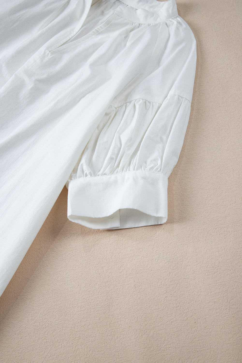 White Solid Color Ruched Bubble Sleeve V Neck ShirtMaterial:100%Cotton

• The ruched detailing on the sleeves adds a touch of texture and visual interest, making this top a standout choice for any occasion. 
• Craf