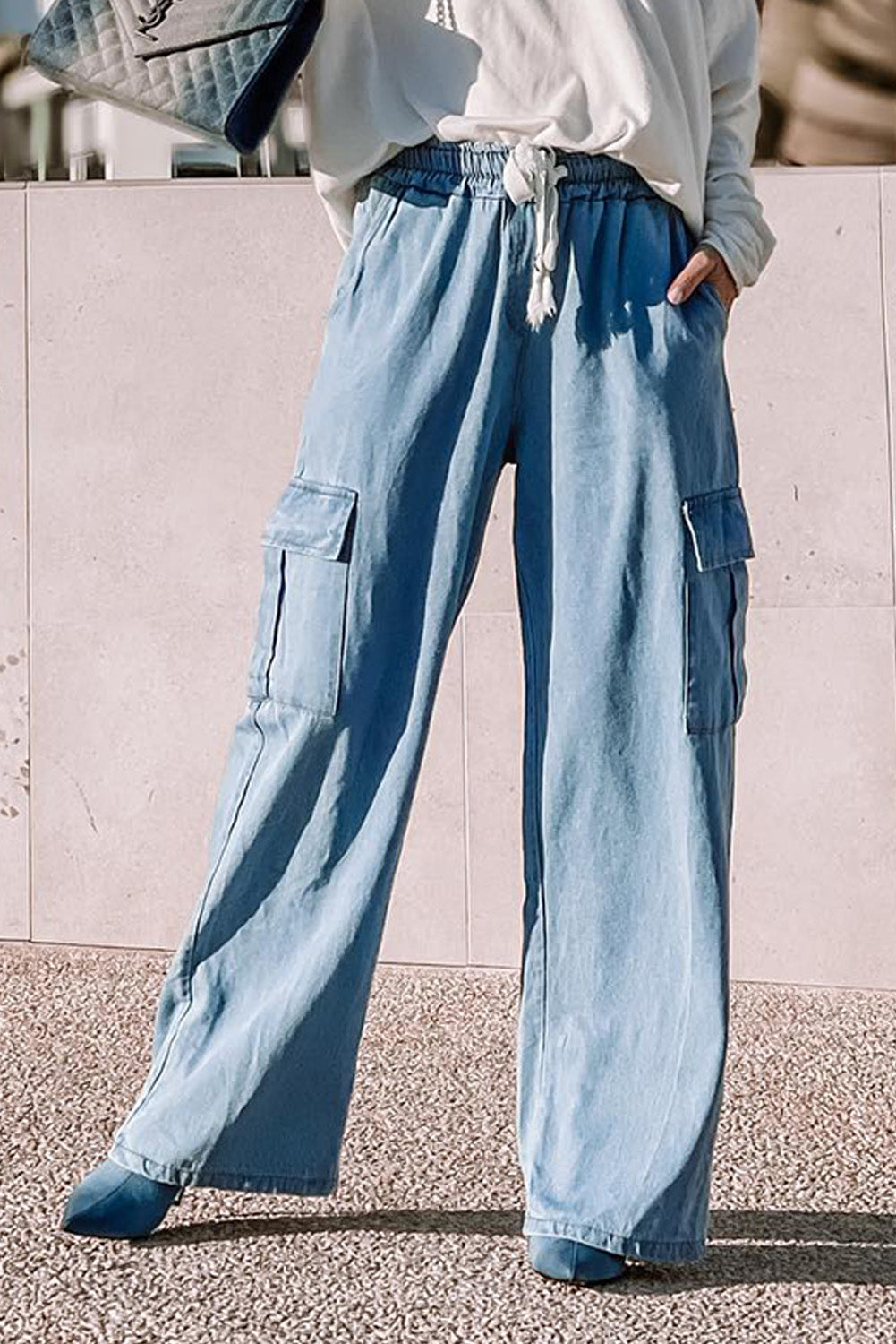 Sky Blue Drawstring High Waist Cargo Pocket Wide Leg JeansMaterial:100%Lyocell



		The high-waist jeans allow for freedom of movement
	
	
		The cargo pockets add a touch of utility and functionality
	
	
		You can e