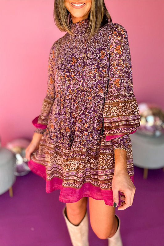 Purple Floral Print Smocked Puff Sleeve High Neck Mini DressMaterial:100%Polyester

• Stand out in the crowd with this dress, perfect for a boho-chic look that exudes elegance and charm.
• The shirred detailing on the bodic