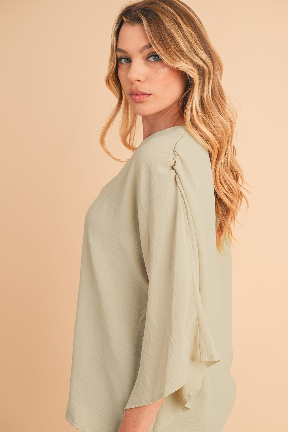 Parchment Solid Color Crinkled V Neck Ruffled Sleeve BlouseMaterial:100%Polyester



		The blouse comes in a solid color, which provides a clean and versatile look. 
	
	
		The crinkled effect also makes the blouse resis