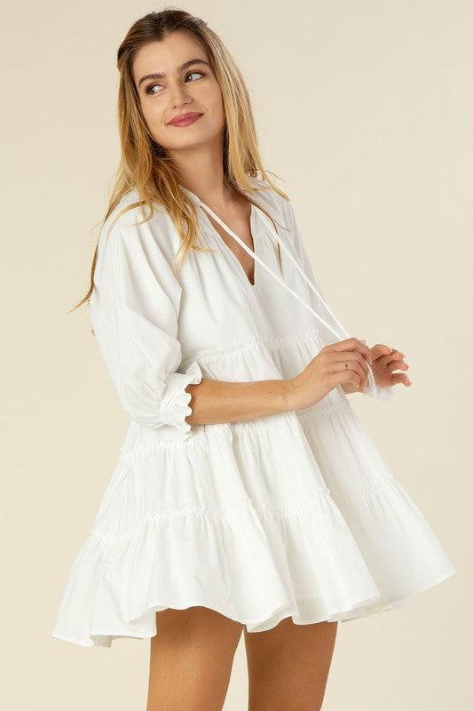 Tiered mini dress with tassel- Tiered mini dress with tassel- Pattern type : solid- Neck line : V neck- Sleeve type : raglan sleeves- Sleeve length : 3/4 sleeves- Stretch : no stretch- Sheer : l