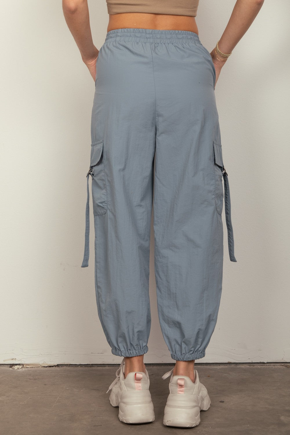 VERY J Elastic Waist Woven Cargo PantsStay on-trend with these Y2K-inspired elastic waist solid woven cargo pants featuring a utility design perfect for everyday wear. The side pockets and D rings add a 