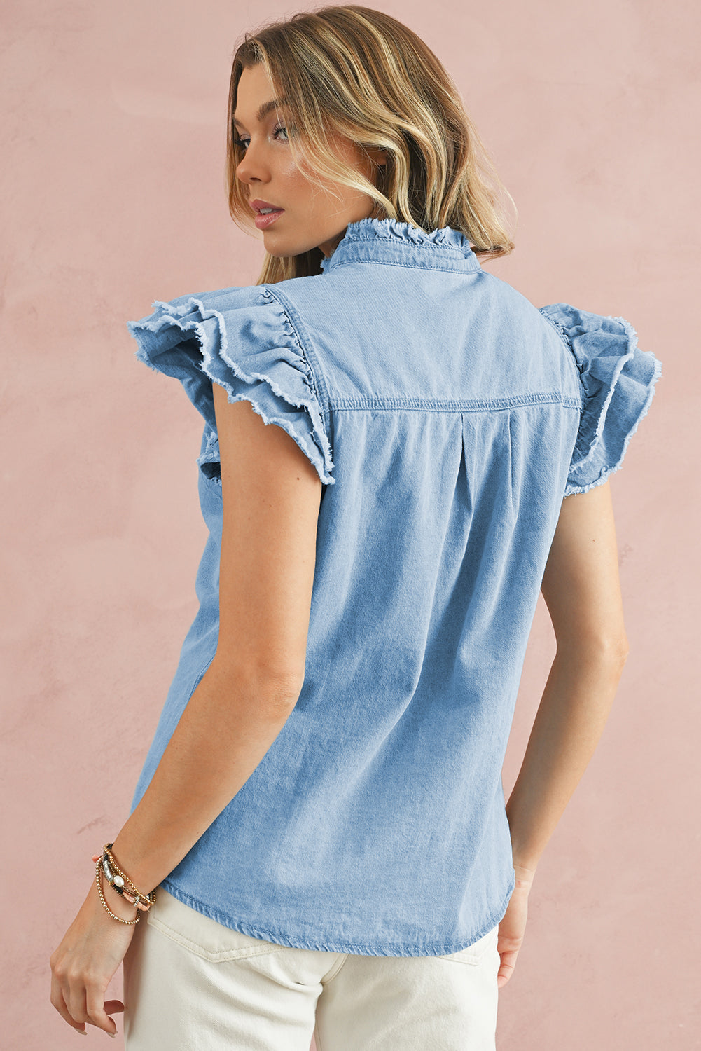 Beau Blue Button Front Ruffled Flutter Frayed Denim TopMaterial:100%Cotton



		The ruffled flutter sleeves create a playful and flirty look, adding movement and charm to the overall design.
	
	
		The frayed detaili