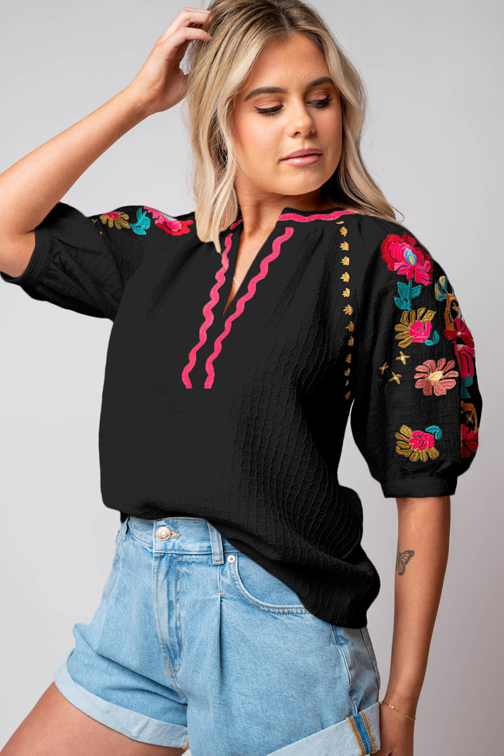 Black Floral Embroidered Ricrac Puff Sleeve Textured BlouseMaterial:100%Polyester

• Intricately detailed floral embroidery adds a touch of whimsy to the classic black hue, perfect for day-to-night transitions.
• The playf