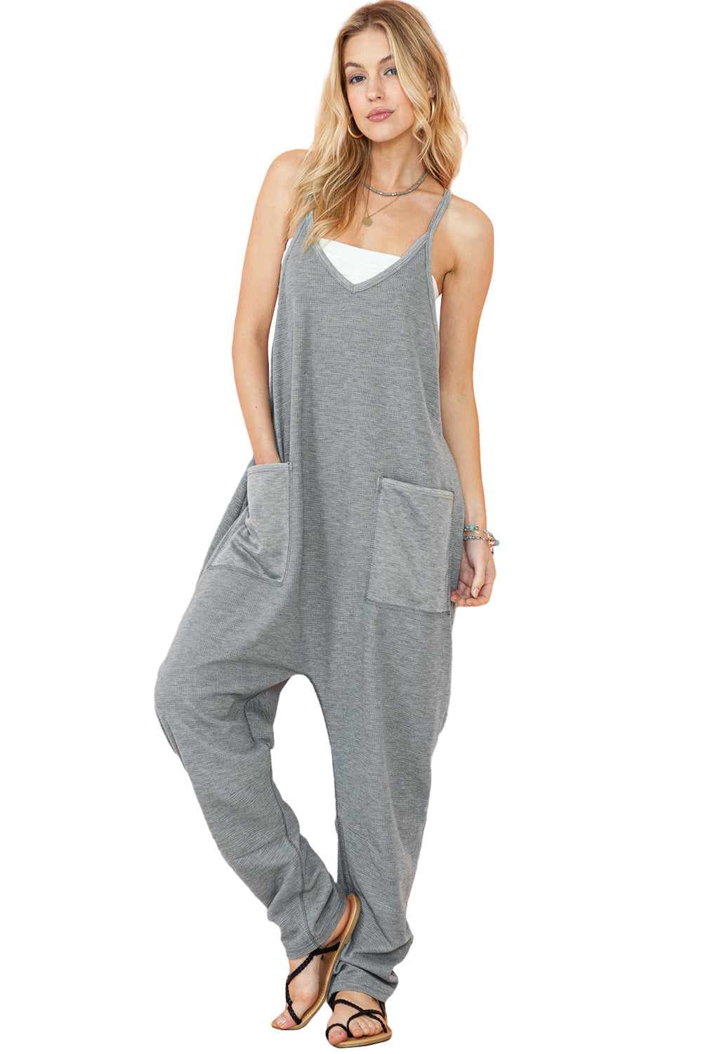 Gray Waffle Knit Spaghetti Strap Pocketed JumpsuitMaterial:95%POLYESTER+5%ELASTANE



		This jumpsuit features delicate spaghetti straps, which give it a feminine and summery look. 
	
	
		The thin straps allow 